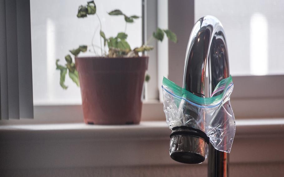 A zip-top bag covers Jamie Williams’s kitchen faucet at her Aliamanu Military Reservation home in Honolulu. 