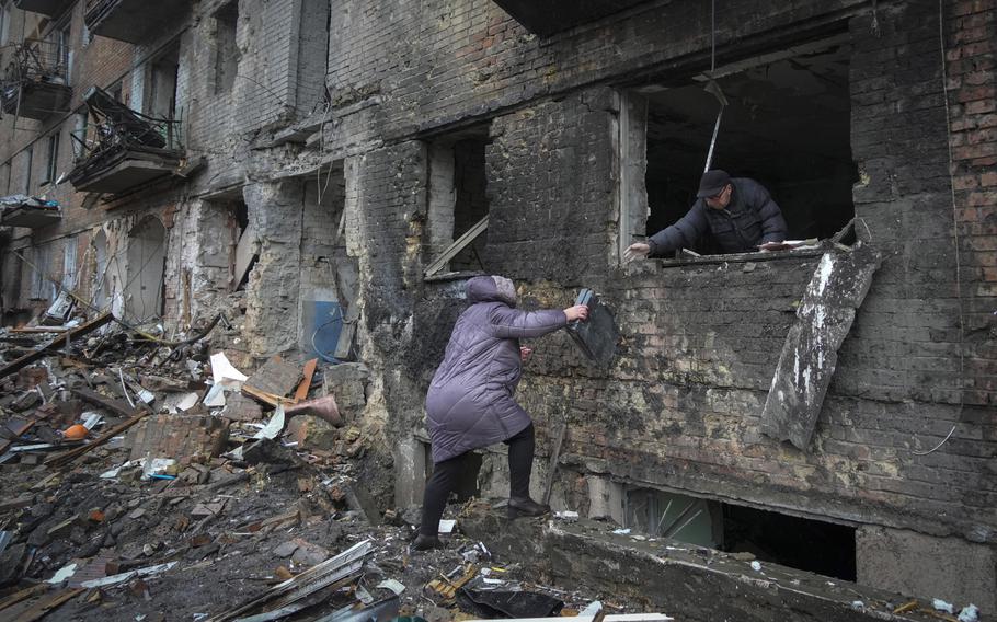 People gather their belongings from a damaged house after Russian shelling in the town of Vyshgorod outside the capital Kiev, Ukraine, Thursday, Nov. 24, 2022. About 70% of the Ukrainian capital was left without power on Thursday morning after Moscow unleashed yet another devastating missile barrage on Ukraine’s energy infrastructure, Kyiv’s mayor said. 
