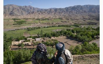 Taliban police officers look out at the crops and homes that were destroyed by flash floods in Chesht-e-Sharif, Herat on May 10, 2024