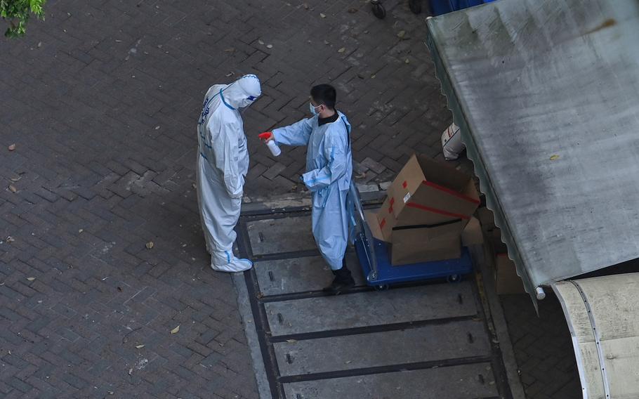 A policeman wearing personal protective equipment is sprayed with disinfectant during a COVID-19 lockdown in the Jing’an district in Shanghai, China, on April 7, 2022. 