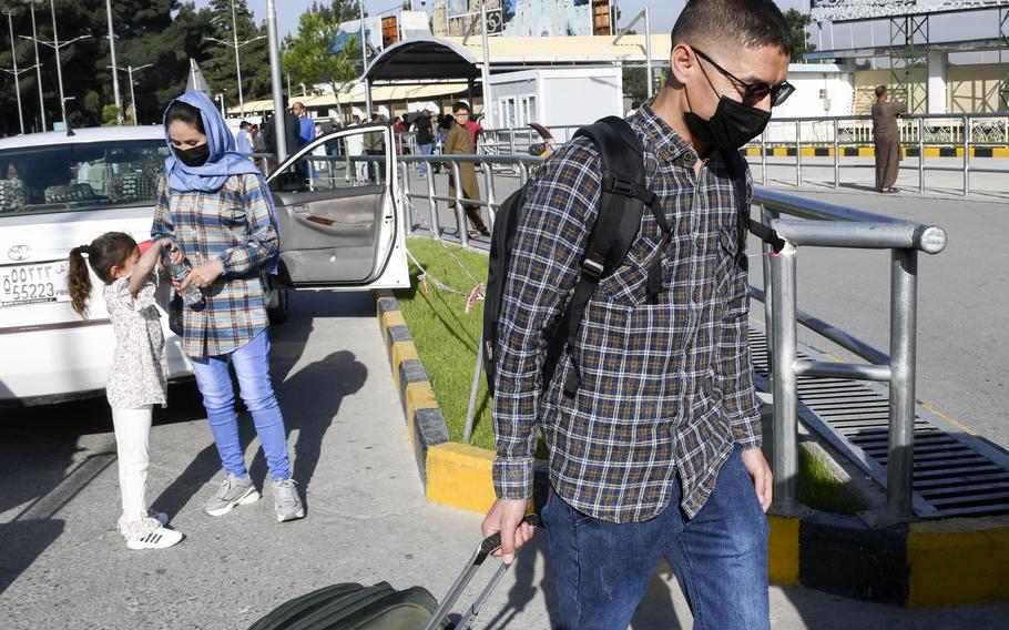 Mohammed Naiem Asadi, his wife Rahima, and their daughter Zainab prepare to leave for the U.S. after arriving at Hamid Karzai International Airport in Kabul, Afghanistan, June 1, 2021. The family has received death threats from the Taliban and obtained parole, a temporary status for noncitizens to come to America. 