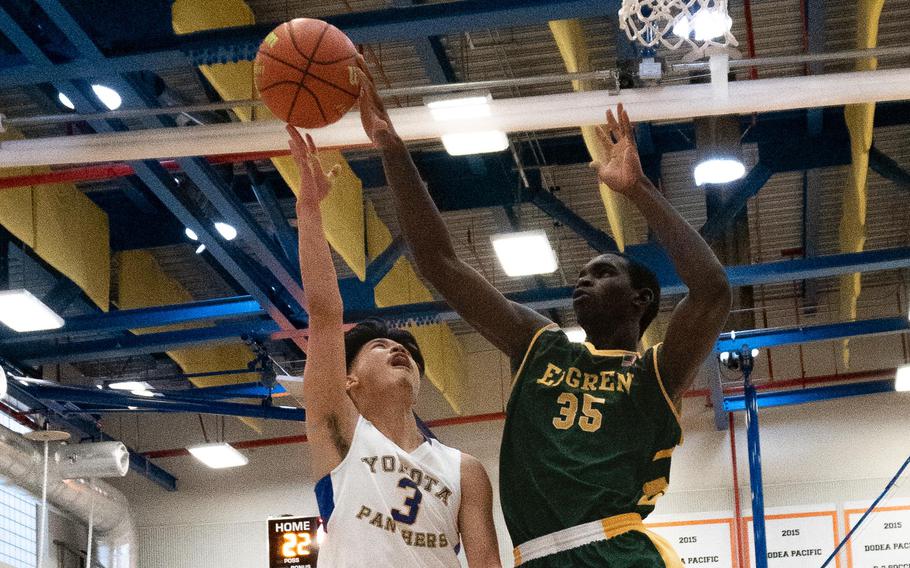 Yokota's Dylan Tomas has his shot blocked by Robert D. Edgren's O'moj Reeves during Friday's DODEA-Japan boys basketball tournament game. The Panthers won 71-45.