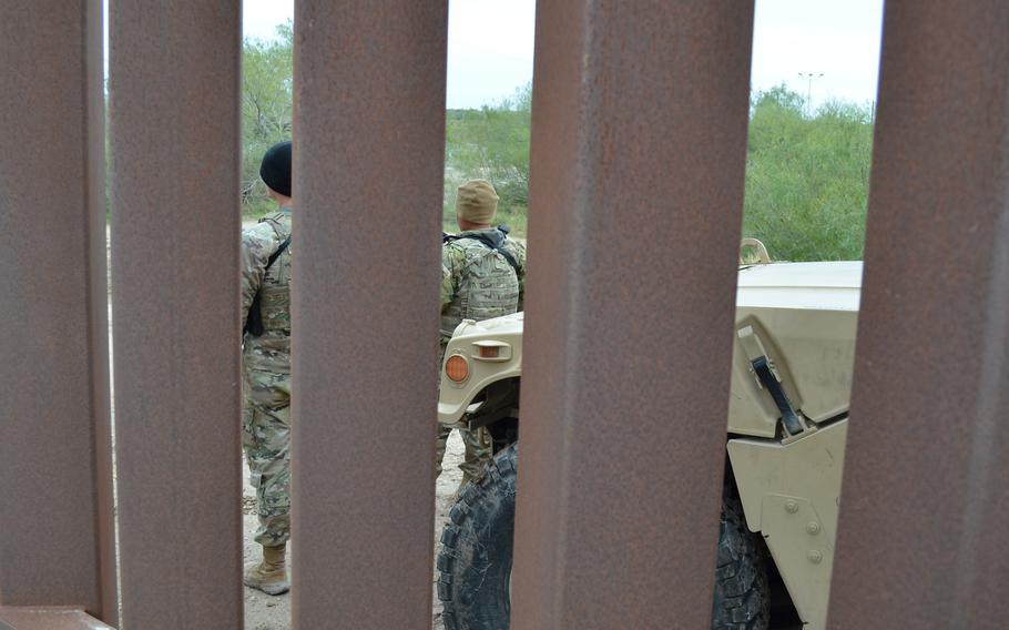 Two Texas National Guard soldiers work Jan. 21, 2022, at an observation post near the state’s border with Mexico as part of Operation Lone Star. The mission began in March with 500 troops and has surged to about 10,000 in the last three months. 