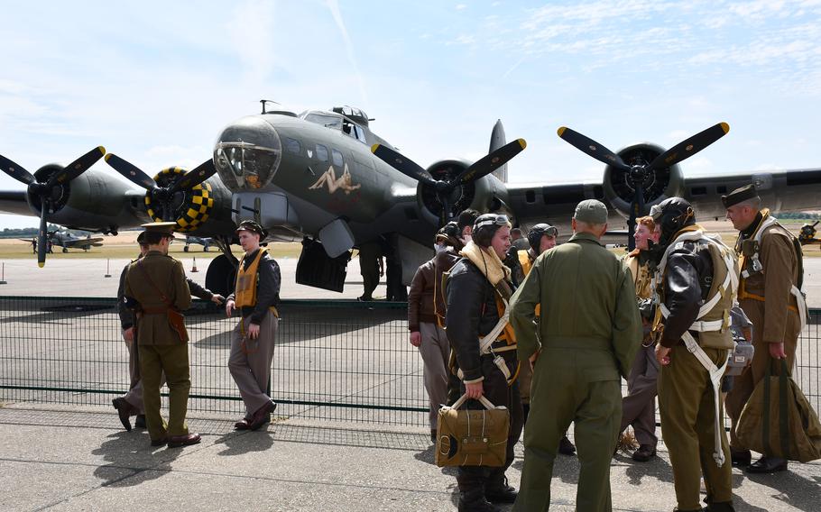 Reenactors portraying WWII-era U.S. Army Air Forces service members stand in front of the B-17, most commonly known as the Sally B, at the Duxford Air Show.