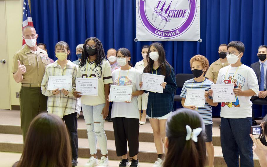 Marine Corps Installations Pacific commander Maj. Gen. Stephen Liszewski presents awards to American and Japanese students who took part in a cultural exchange program at Camp Lester, Okinawa, Oct. 2, 2022. 