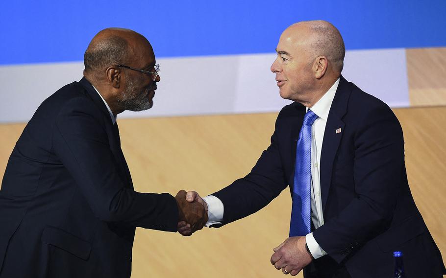 Prime Minister of Haiti Ariel Henry, left, and U.S. Homeland Security Secretary Alejandro Mayorkas shake hands during a plenary session of the 9th Summit of the Americas on Friday, June 10, 2022, in Los Angeles. 