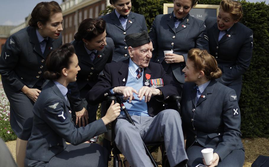 World War II British D-Day veteran Bernard Morgan, aged 95, who was a sergeant decoder in the Royal Air Force 83 Group Control Centre and landed at Gold beach on the afternoon of June 6, 1944, speaks to the ‘D-Day Darlings’ singing group after they posed for a group photograph on the ‘D-Day 75 Garden’, for the 75th anniversary of D-Day at the RHS (Royal Horticultural Society) Chelsea Flower Show, in London, Monday, May 20, 2019. World-renowned and quintessentially British, the annual show is a celebration of horticultural excellence and innovation. 