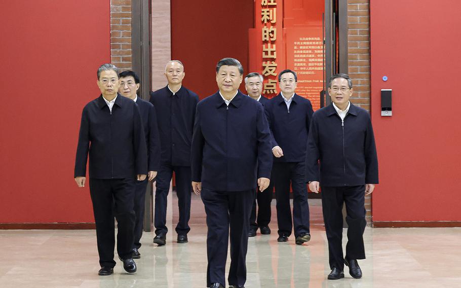 Chinese President Xi Jinping, center, leads members of the Politburo of the Communist Party of China’s central committee as they visit an exhibition in Yan’an, northwestern China’s Shaanxi Province on Thursday, Oct. 27, 2022. 