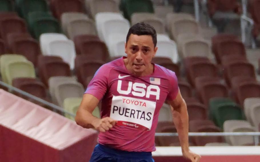 Paralympian Luis Puertas, an Army veteran who lost both legs to a roadside bomb in Iraq, runs in a 200-meter event at National Stadium in Tokyo, Friday, Sept. 3, 2021.