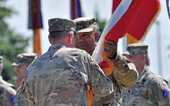 Incoming commander of U.S. Army Europe and Africa Gen. Darryl Williams takes the unit’s colors from Gen. Tod Wolters in Wiesbaden, Germany, on June 28, 2022. Williams took command of the unit from Gen. Christopher Cavoli at the ceremony.