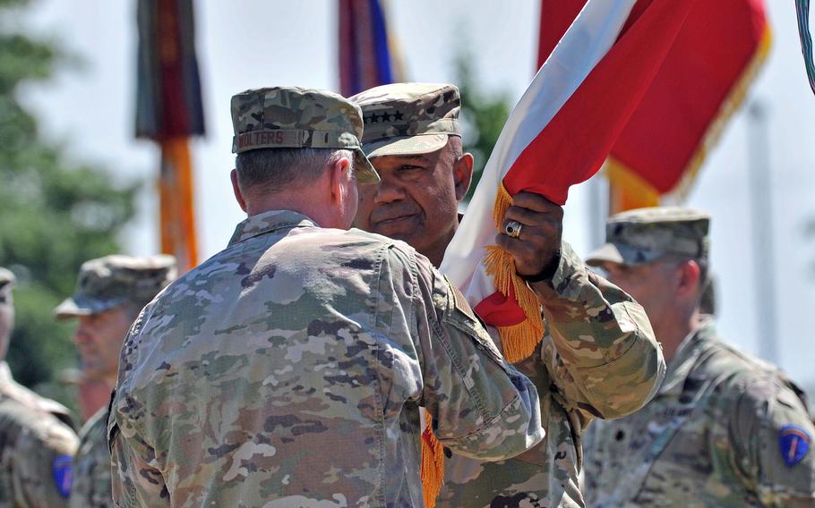 Incoming commander of U.S. Army Europe and Africa Gen. Darryl Williams takes the unit’s colors from Gen. Tod Wolters in Wiesbaden, Germany, on June 28, 2022. Williams took command of the unit from Gen. Christopher Cavoli at the ceremony.