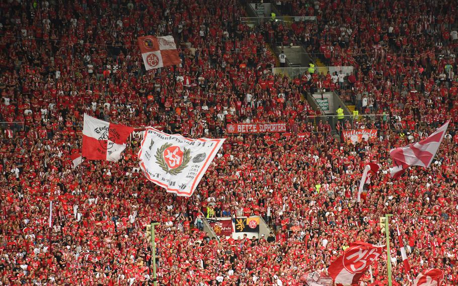 Fans dressed in FC Kaiserslautern apparel cheer on the soccer team during a game at Fritz Walter Stadium, Sunday, Aug. 28, 2022.