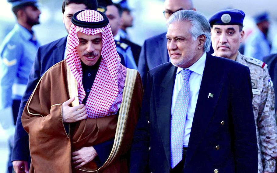 In this photo released by Ministry of Foreign Affairs, Pakistani's Foreign Minister Ishaq Dar, right, greets his Saudi counterpart Prince Faisal bin Farhan upon his arrival at a military airbase in Rawalpindi, Pakistan, on April 15, 2024.