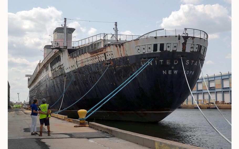 Susan Gibbs and Jorge Gonzalez look up at the SS United States ocean liner at Pier 82 in Philadelphia on Friday, July 23, 2021. The ship was the fastest passenger ship built and the largest ever made in the U.S., according to the SS United States Conservancy. Gibbs grandfather, William Francis Gibbs, was the self-taught naval architect and marine engineer of the ship. 