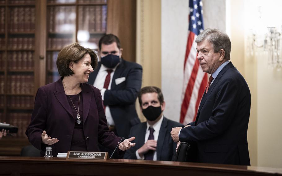 Sen. Amy Klobuchar, D-Minn., speaks with Sen. Roy Blunt, R-Mo., during a Senate Rules Committee hearing on Capitol Hill on May 11, 2021. 