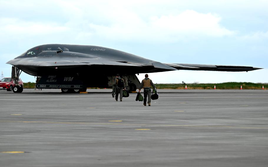 Two 393rd Expeditionary Bomb Squadron pilots approach a B-2 Spirit in Keflavik, Iceland, on Aug. 15, 2023.