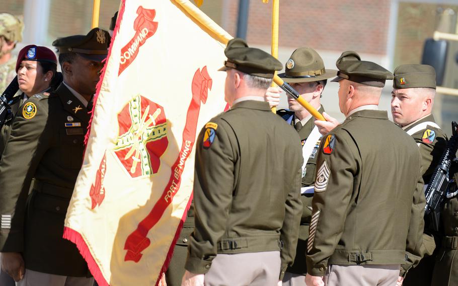 Soldiers at attention stand disturbingly close to a flag. 