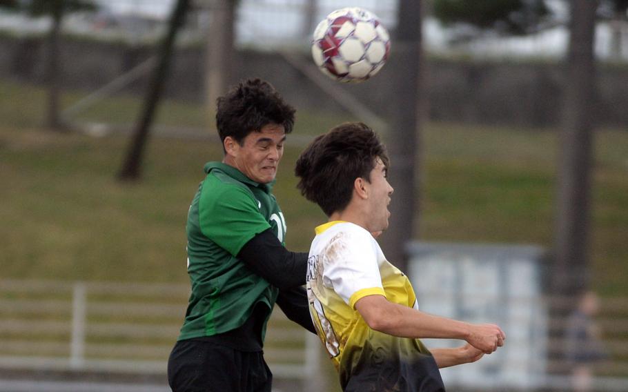 Kubasaki's Justin Murray and Kadena's Tyler Smith go up to head the ball during Wednesday's Okinawa boys soccer match. The Panthers won 3-2.