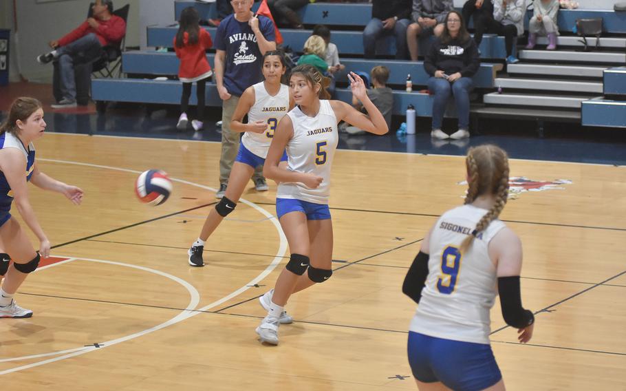 Angeliah Barraza-Hernandez, second from left, Ryleigh Denton and Emese Hriczu all look back toward Sigonella libero Isabelle Balleza in hopes she can dig the ball after an Aviano serve on Saturday, Sept. 17, 2022.