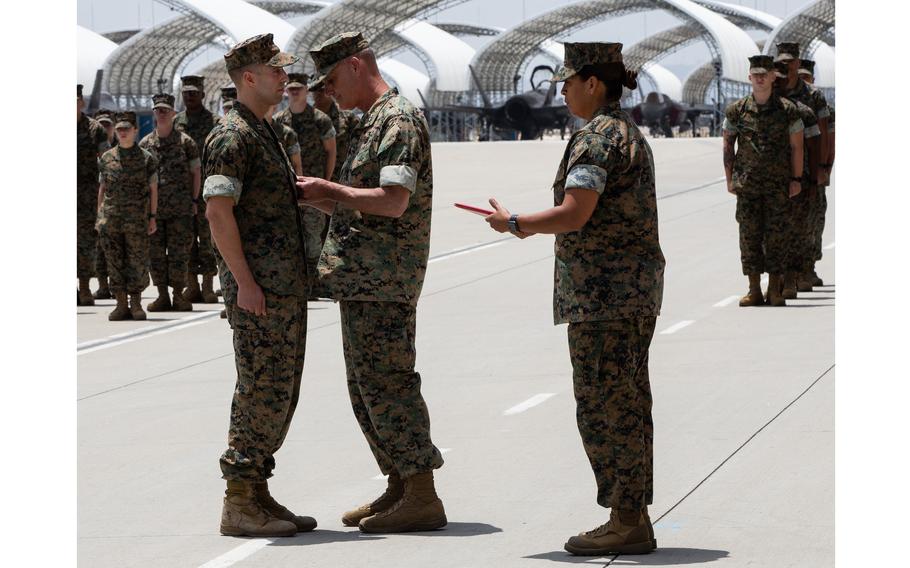 U.S. Marine Corps Capt. Michael Wolff, a KC-130J Super Hercules pilot with Marine Aerial Refueler Transport Squadron 352, Marine Aircraft Group 11, 3rd Marine Aircraft Wing (MAW), receives the Distinguished Flying Cross from Maj. Gen. Bradford J. Gering, 3rd MAW commanding general, at Marine Corps Air Station Miramar, Calif., May 25, 2022. 