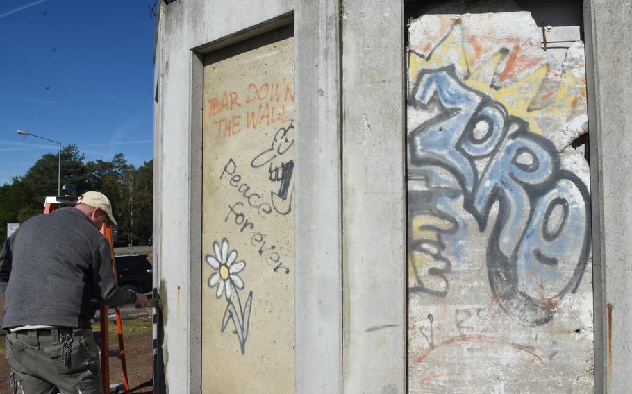 Chris Lembach, a civil engineer squadron worker at Ramstein Air Base in Germany, reinforces the connecting pieces between three slabs of the Berlin Wall on Oct. 1, 2021. The squadron recently moved the display to a more visible spot as part of celebrations for the Day of German Unity on Sunday.