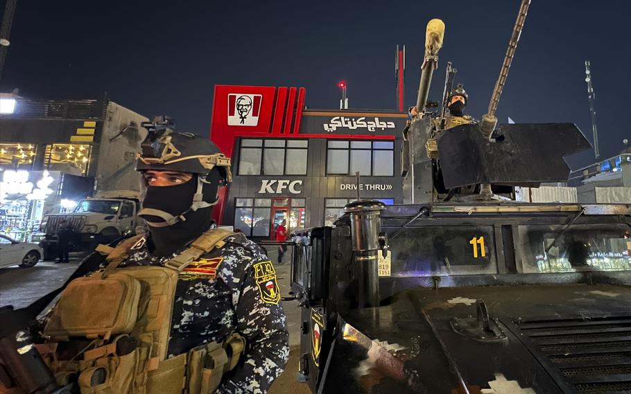 Iraqi security forces stand guard in front of Kentucky Fried Chicken restaurant in Baghdad, Wednesday, June 5, 2024. The recent protests — apparently organized by supporters of Iran-backed, anti-American militias in Iraq — reflect surging anger against the United States, Israel’s top ally, over the war in Gaza. 