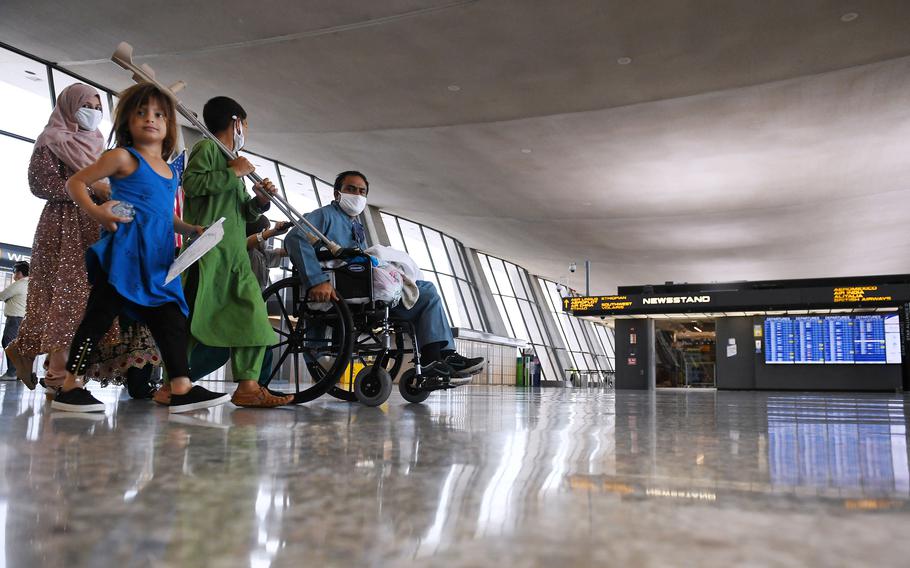 Afghan refugees arrive at Dulles International Airport on August 27, 2021, in Dulles, Va., after being evacuated from Kabul following the Taliban takeover of Afghanistan.