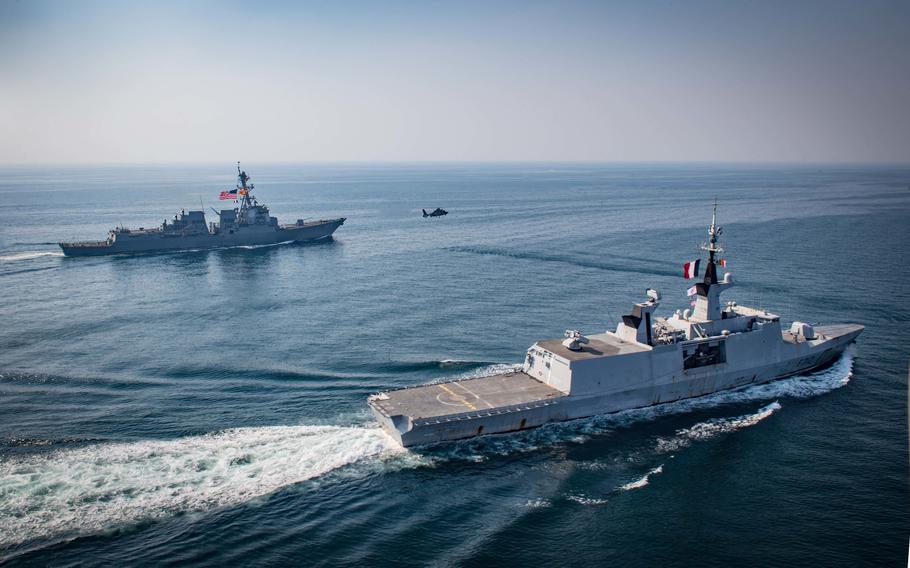 The French frigate FS Courbet, right, steams alongside the destroyer USS Jason Dunham as a French AS-565 Panther helicopter flies between them in the Persian Gulf in 2018. France, along with Italy and Germany, are proposing to form a European Union Red Sea task force to defend shipping in the Middle East, as the U.S.-led Operation Prosperity Guardian continues in the area. 