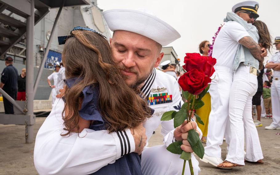 A sailor embraces his daughter.