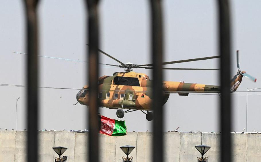 An Afghan Air Force's helicopter rovers near the Afghan Parliament house in Kabul on Aug. 2, 2021.