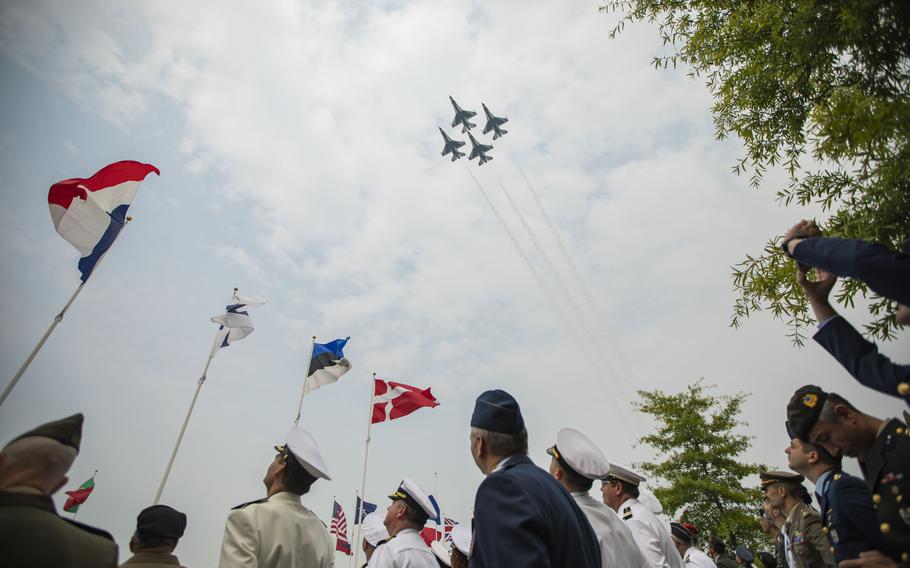 NATO officials watch as the U.S. Air Force Thunderbirds fly over in celebration of NATO’s Norfolk headquarters’ 20th anniversary June 7, 2023 in Norfolk, Va. Leadership showcased the Allied Command Transformation’s work with an exhibit honoring its history before a ceremonial flag raising.