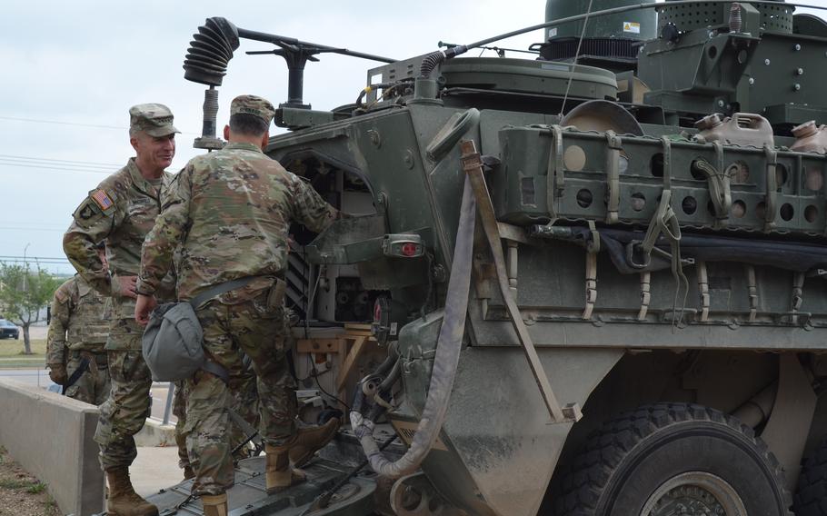 Lt. Gen. Sean Bernabe, commander of III Corps and Fort Hood, Texas, shows Gen. James McConville, Army chief of staff, the modifications of a Stryker armored vehicle during a multination training exercise on Thursday, April 20, 2023.