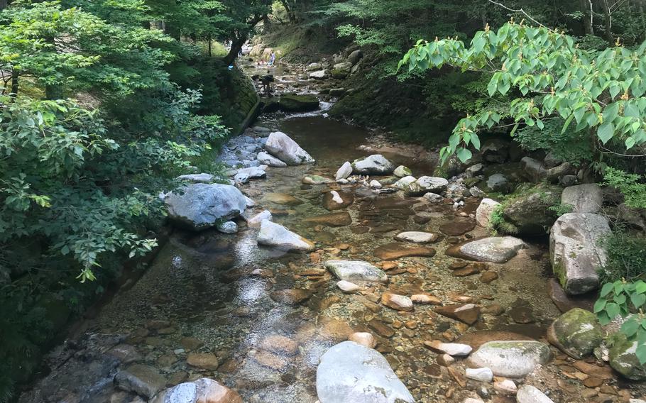 Visitors swim upstream of Jakuchikyo Camping Ground in Yamaguchi prefecture, Japan.
