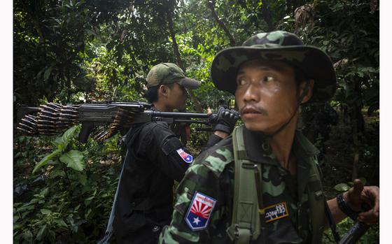 KNU fighters from Brigade 7 move through a jungle after returning from the front line in Myanmar. 
