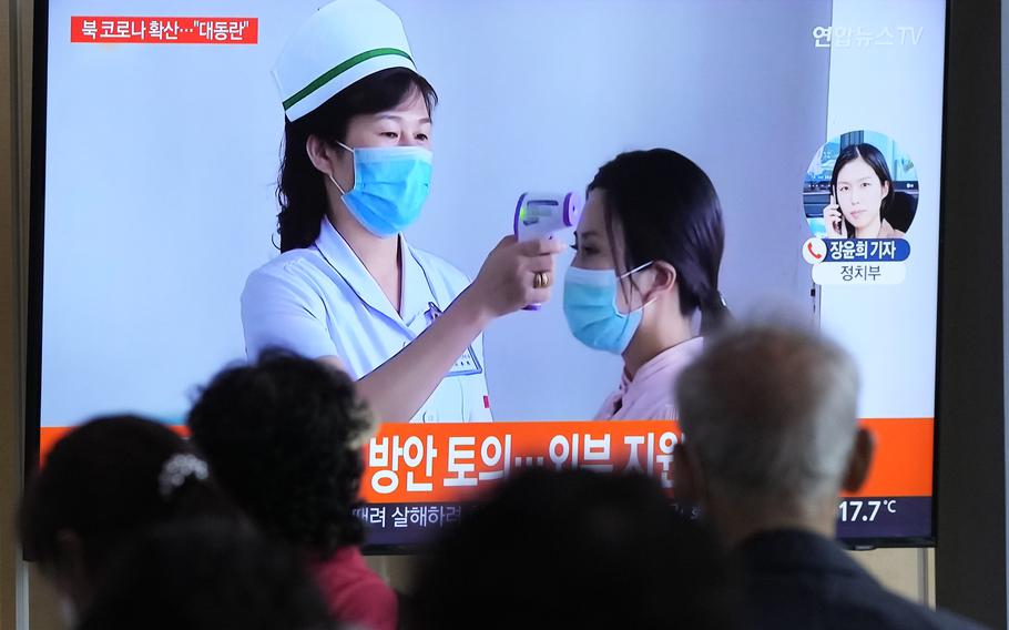 People watch a TV screen showing a news report about the COVID-19 outbreak in North Korea, at a train station in Seoul, South Korea, Saturday, May 14, 2022. North Korea on Saturday reported 21 new deaths and 174,440 more people with fever symptoms as the country scrambles to slow the spread of COVID-19 across its unvaccinated population. 