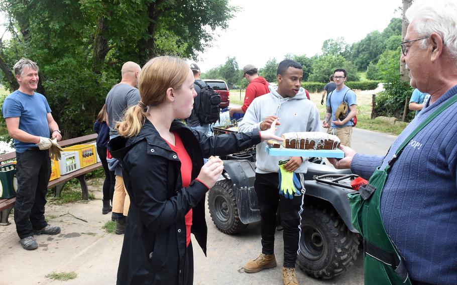 Residents of Rittersdorf, Germany, thank airmen with refreshments for helping them clean up their village in the aftermath of severe flooding last month. More than two dozen airmen from Spangdahlem Air Base and a few from Ramstein Air Base helped villagers clean up debris along the Nims River on July 31, 2021.