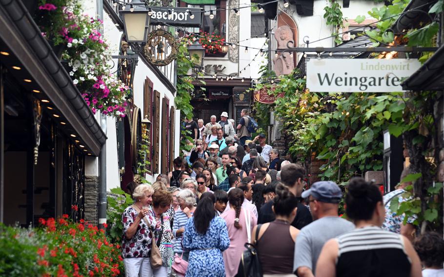 Hordes of tourists make their way along the Drosselgasse in Ruedesheim, Germany. Lined with wine taverns, restaurants and cafes, it is the main attraction in this wine-producing town on the Rhine River. 