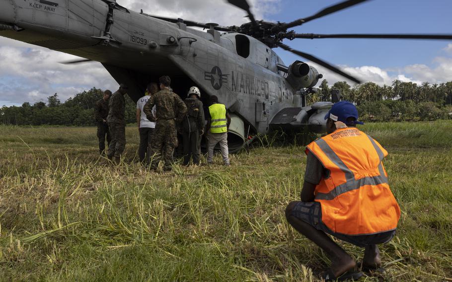 U.S. Marines with the 31st Marine Expeditionary Unit and Papua New Guinea aid worker load supplies onto a CH-53E Super Stallion during a humanitarian assistance and disaster relief operation on Bougainville Island, Papua New Guinea, Aug. 12, 2023. 