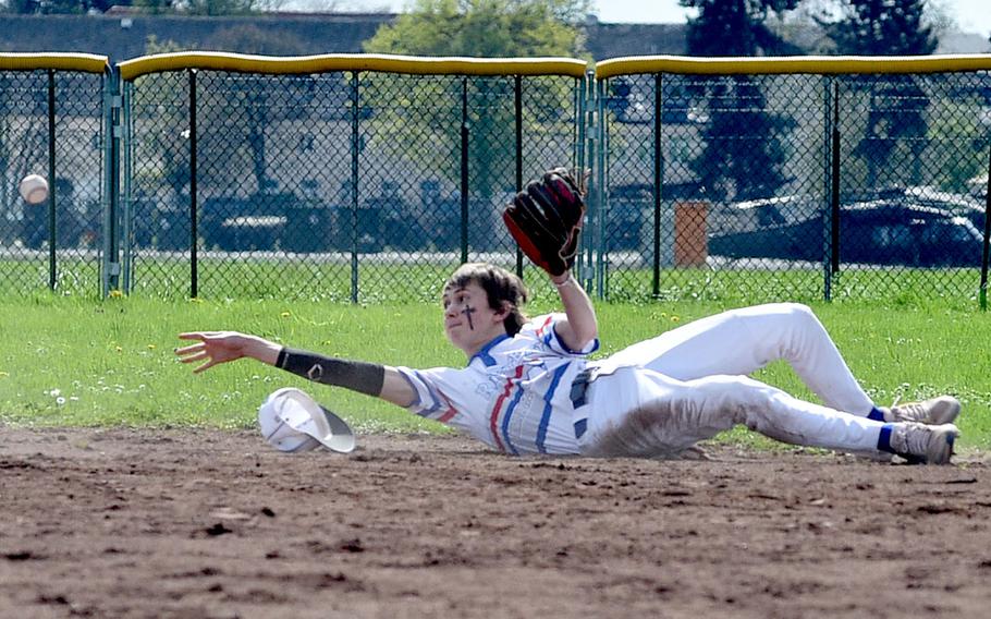 Ramstein second baseman Liam Delp throws the ball to the bag from his back after fielding a ground ball during the second game of a doubleheader against Wiesbaden on April 6, 2024, on Clay Kaserne in Wiesbaden, Germany.