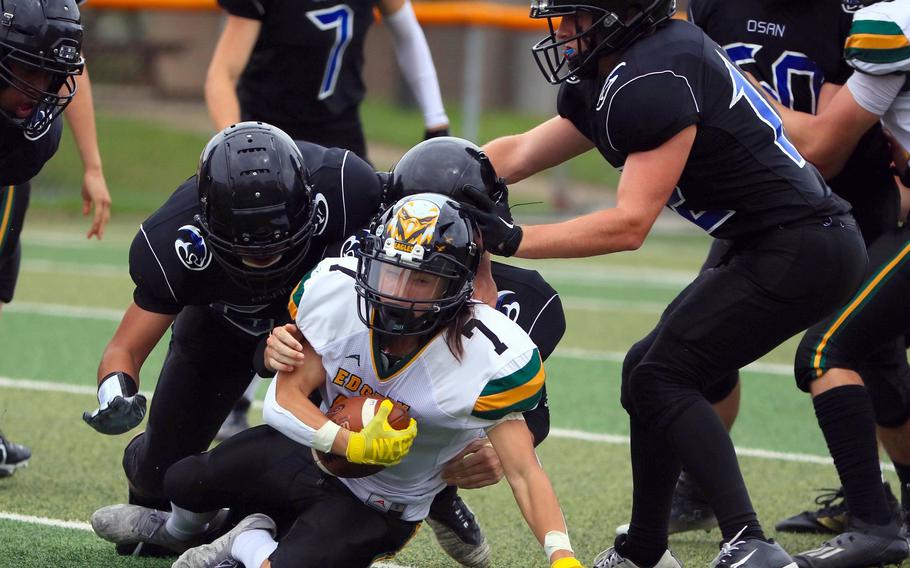 Robert D. Edgren's Haruki Jones gets hauled down by Osan's Timothy Davidson, Benjamin Bettridge and Martin Heffele.