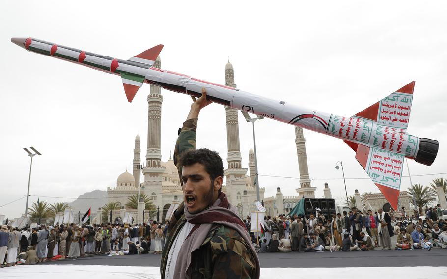 A Houthi supporter raises a mock rocket during a rally against the U.S. and Israel and to support Palestinians in the Gaza Strip, in Sanaa, Yemen, Friday, April. 26, 2024. 