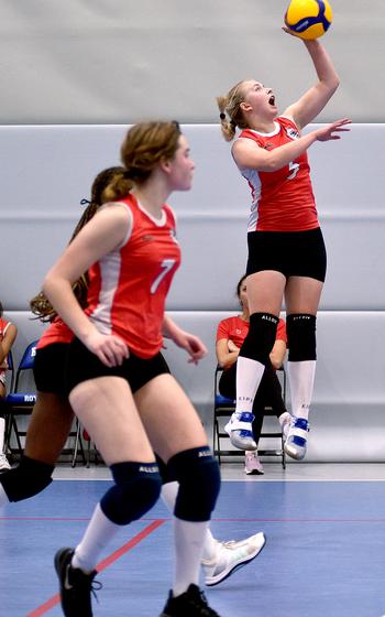 American Overseas School of Rome's Clara Clayton, right, goes for a spike as Annika Kravetsky watches during a pool-play match against Vicenza on Thursday at Ramstein High School at Ramstein Air Base, Germany.

Matt Wagner/Stars and Stripes