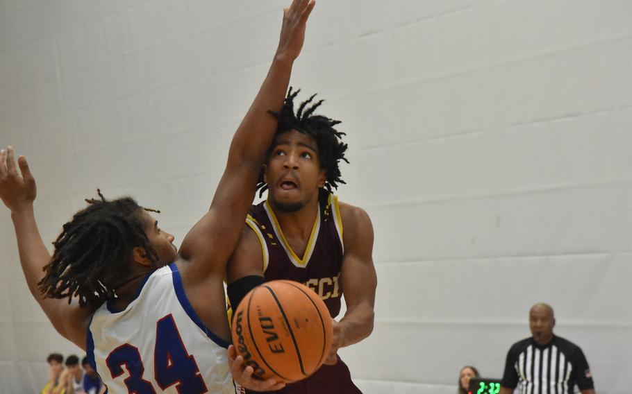 Vilseck’s Brandon Goins gets up a shot past Ramstein’s Tyrell Edwards in a Division I semifinal game at the DODEA European Basketball Championships at Wiesbaden, Germany, on Friday, Feb. 16, 2024.