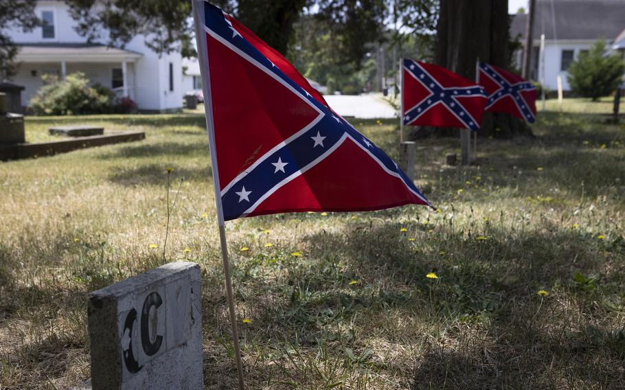 Confederate flags dot graves at the Emporia Cemetery in Emporia, Va. 