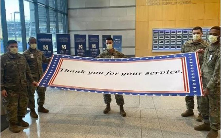 Members of the Massachusetts National Guard pay tribute to Robert St. Clair III,