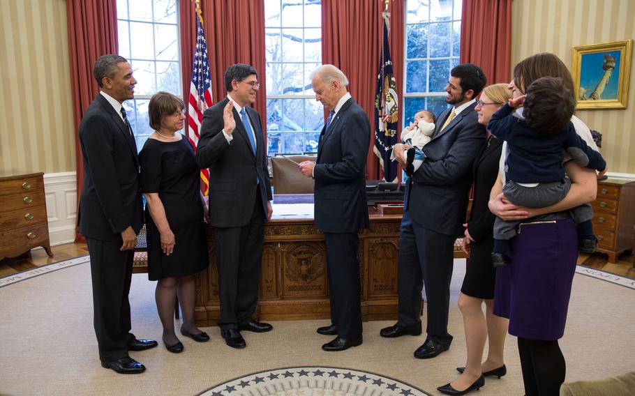 Former President Barack Obama watches as then-Vice President, our current commander in chief, Joe Biden swears in Treasury Secretary Jack Lew during a ceremony in the Oval Office, Feb. 28, 2013. Lew’s family, pictured from left, are: wife Ruth Schwartz;  granddaughter Eliora Lew; son Danny Lew; daughter Shoshana Lew; daughter-in-law Zahava Lew;  and grandson Moshe Lew. 