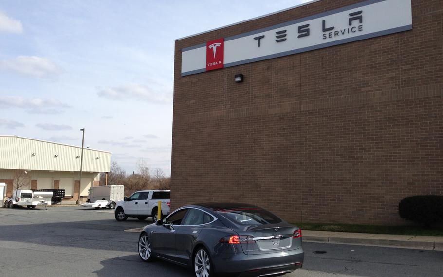 Tesla Model S in front of a Tesla Motors Service facility.