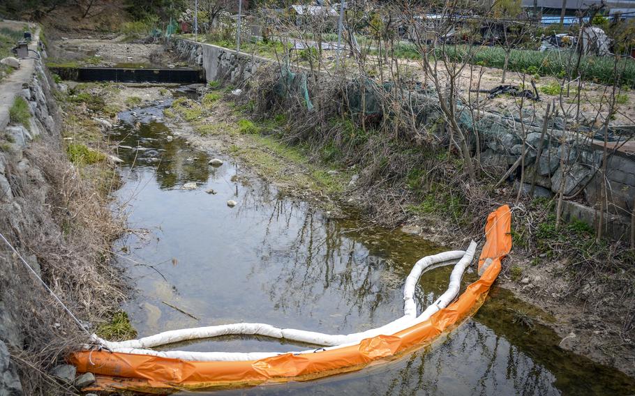 A spill fence dams a stream near Camp Mujuk, a Marine Corps base near Pohang city, South Korea, April 10, 2024.