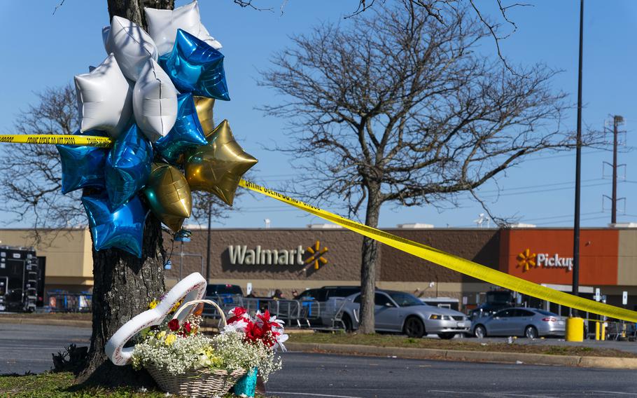 Flowers and balloons have been placed near the scene of a mass shooting at a Walmart, Wednesday, Nov. 23, 2022, in Chesapeake, Va. A Walmart manager opened fire on fellow employees in the break room of the Virginia store, killing several people in the country’s second high-profile mass shooting in four days, police and witnesses said Wednesday.