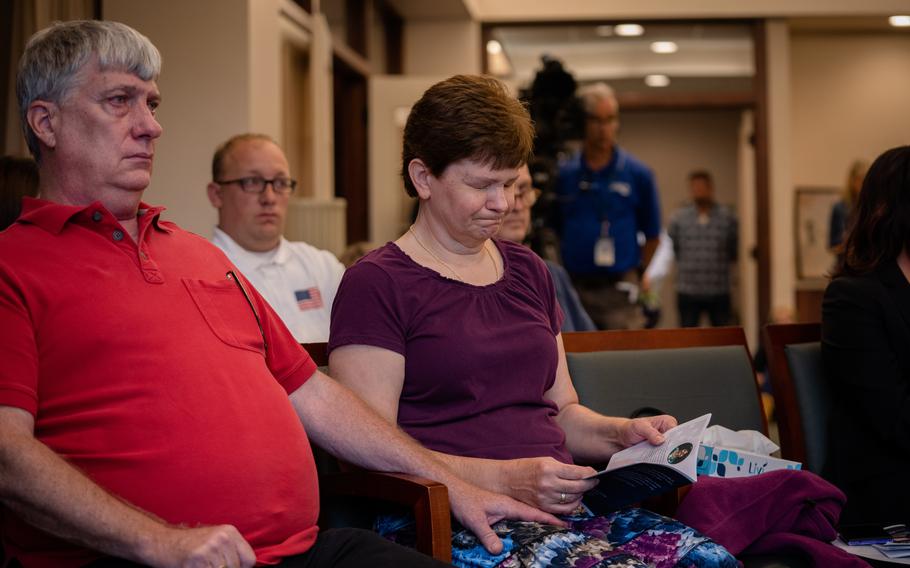 John and Lori Wetlaufer listen during a memorial service for Lori’s stepbrother, James Dean Ryan, and other veterans.